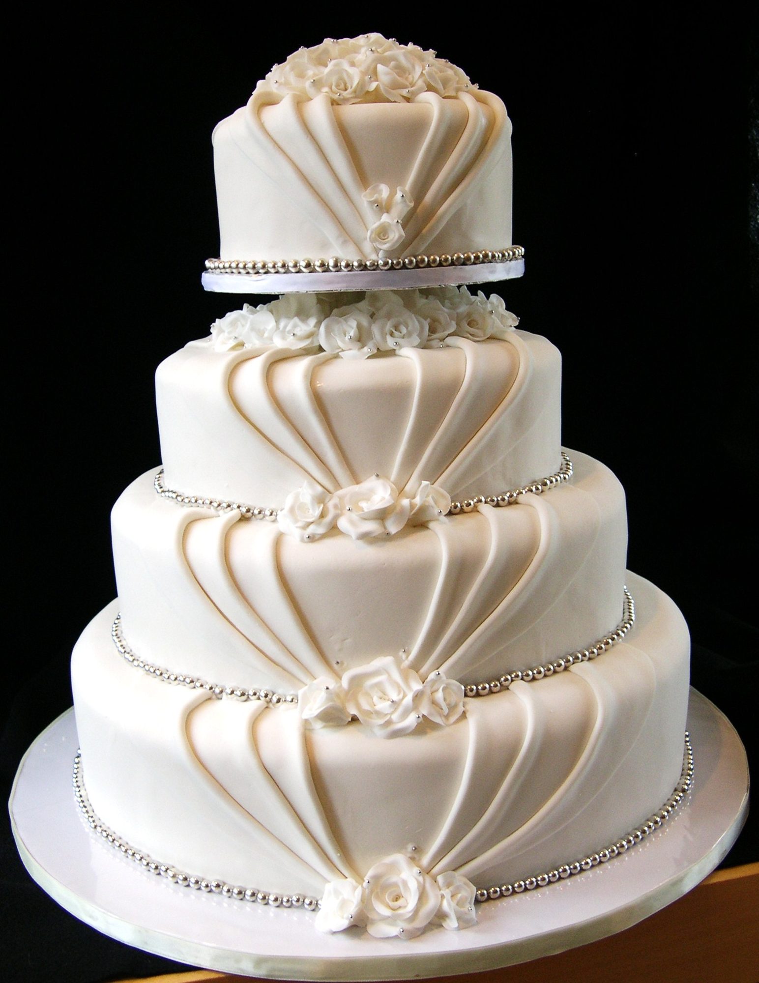 Draped fondant wedding cake with sugar roses